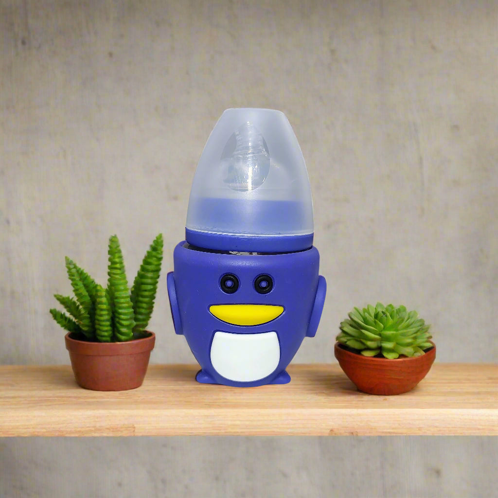 Blue penguin-shaped bottle on a white surface with a blurred indoor background