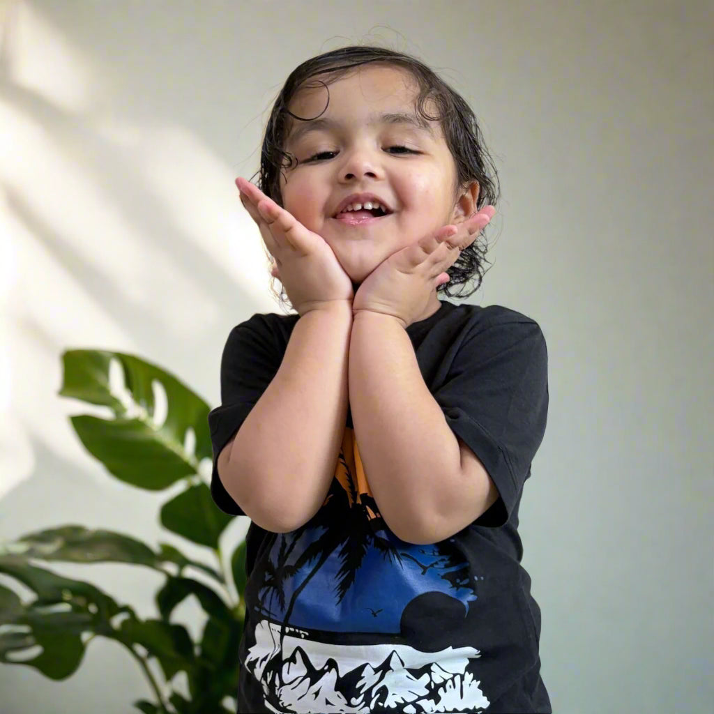 Child with hands on face against a plain wall