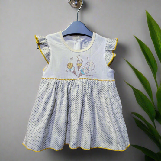 Children's dress with ice cream cone design on a wooden background