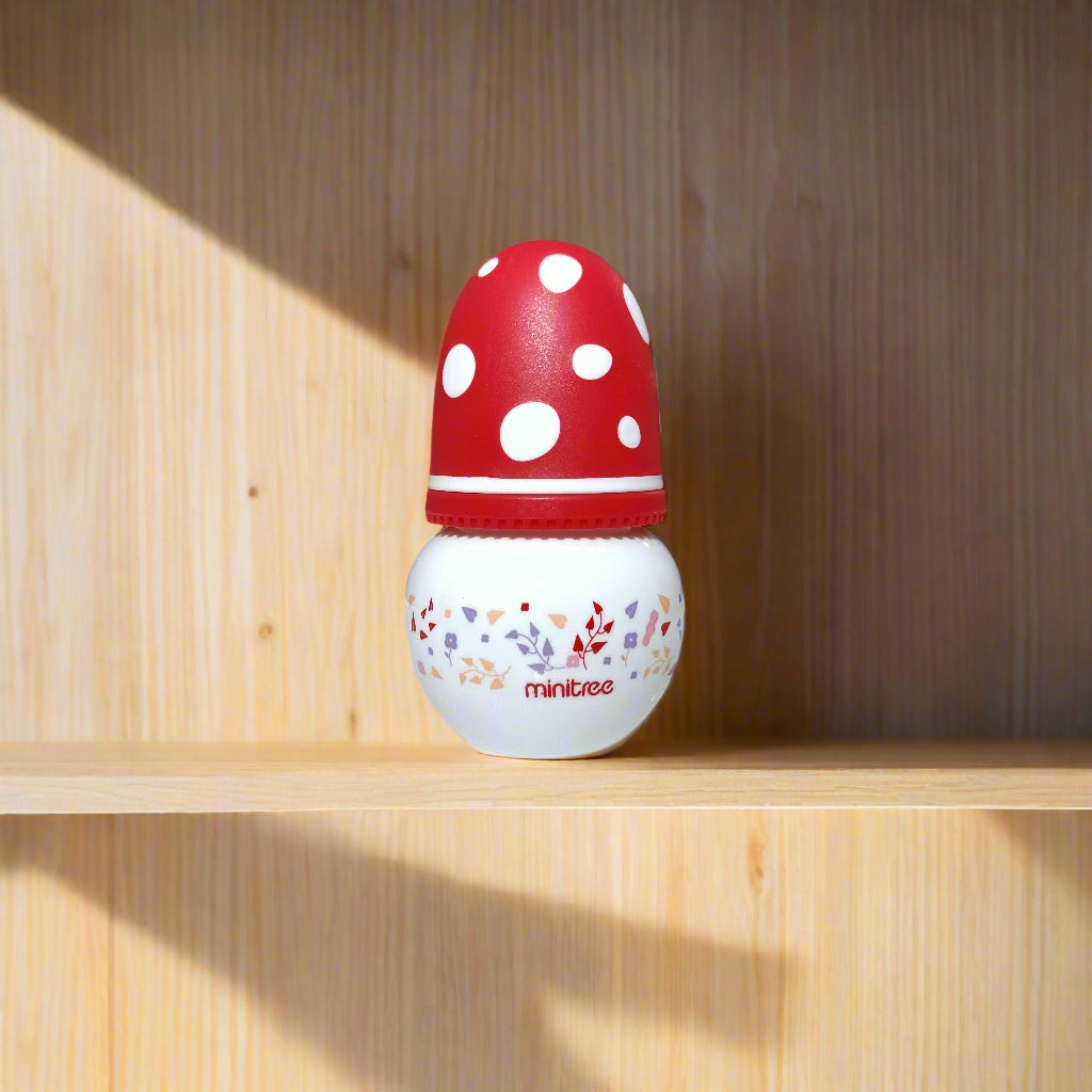 Red and white polka dot door stopper with 'Mintues' branding on a white door.
