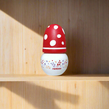 Red and white polka dot door stopper with 'Mintues' branding on a white door.