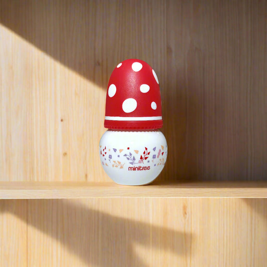 Red and white polka dot door stopper with 'Mintues' branding on a white door.