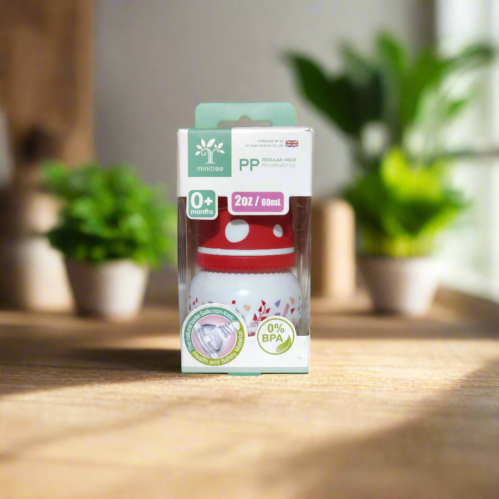 Baby products including a red and white item and a green box with text on a white surface.