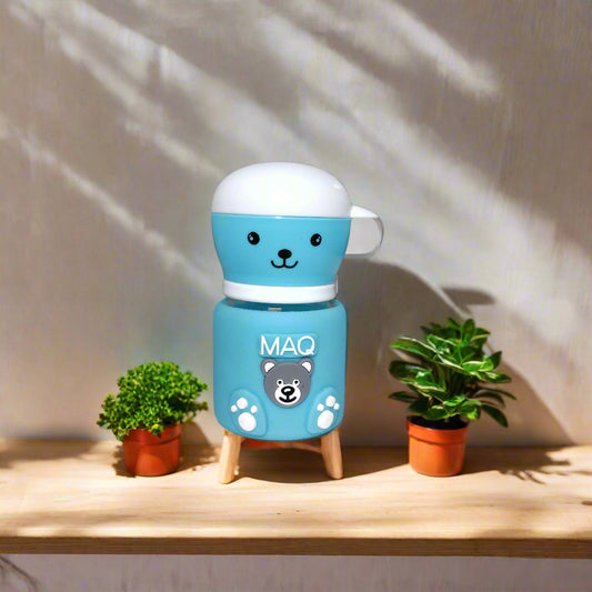 Blue robot toy with 'MAO' branding attached to a white wall.