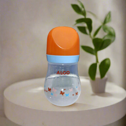 Baby bottle with orange cap and colorful designs on a white surface